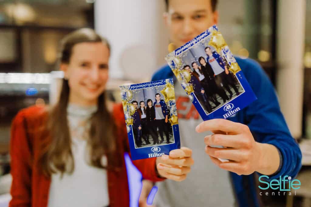 photo booth hire Auckland CBD corporate event — guests with printed photos