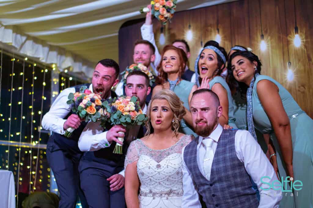 Wedding party celebrating with a photo booth at an event in Auckland.