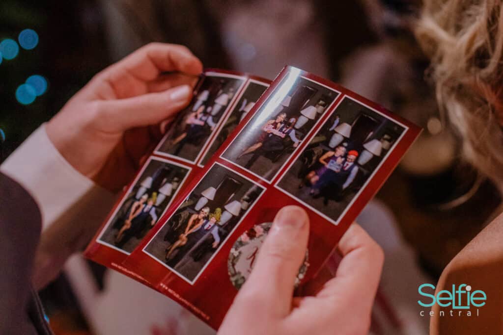 Person holding a photo strip from a photo booth at an event in Auckland.