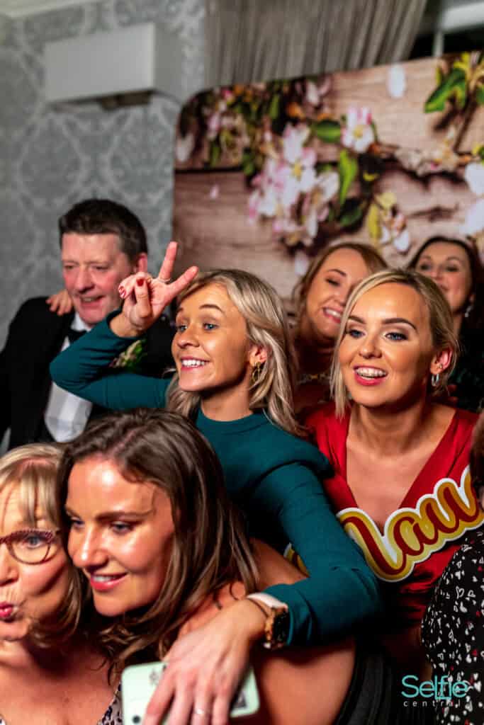 Group of friends enjoying a photo booth at an event in Auckland, New Zealand.