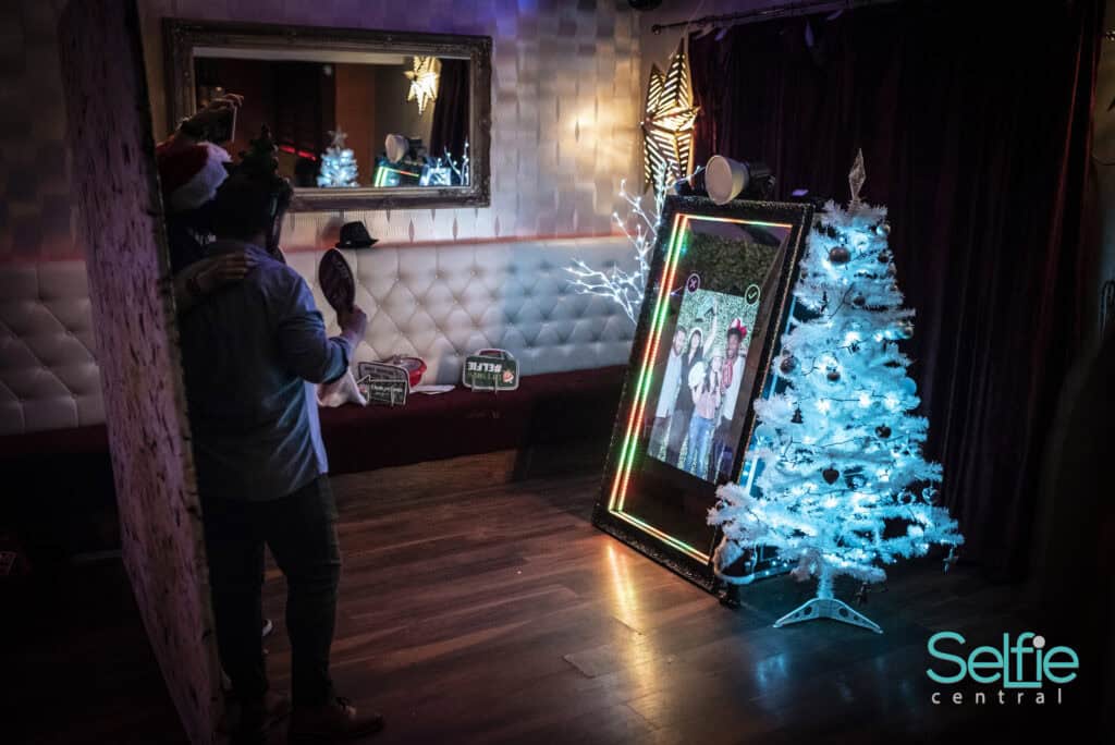 Modern photo booth setup with Christmas decorations at Selfie Central Auckland event.