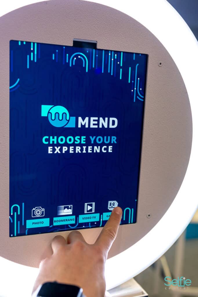 Interactive photo booth touchscreen with vibrant blue display in Auckland.