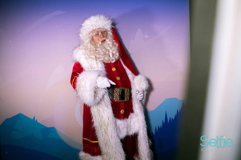Santa Claus at Selfie Central photo booth in Auckland during Christmas event.