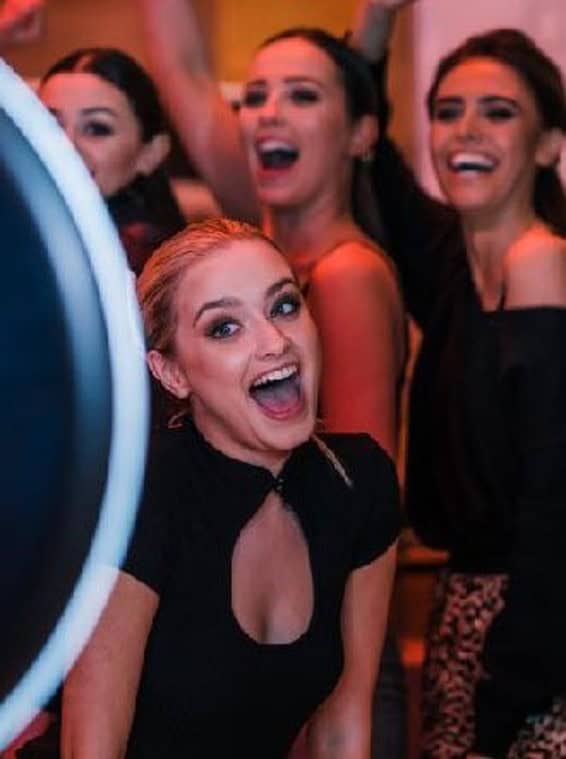 Group of women enjoying photo booth at Auckland event.