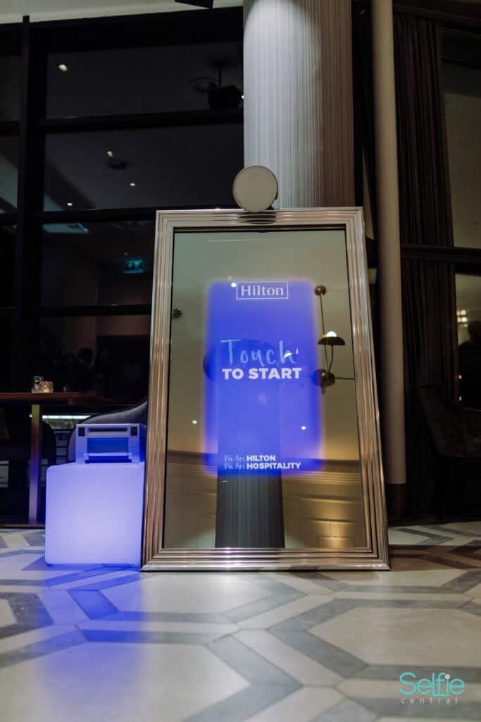 Hilton hotel digital sign with Touch to Start message in lobby.