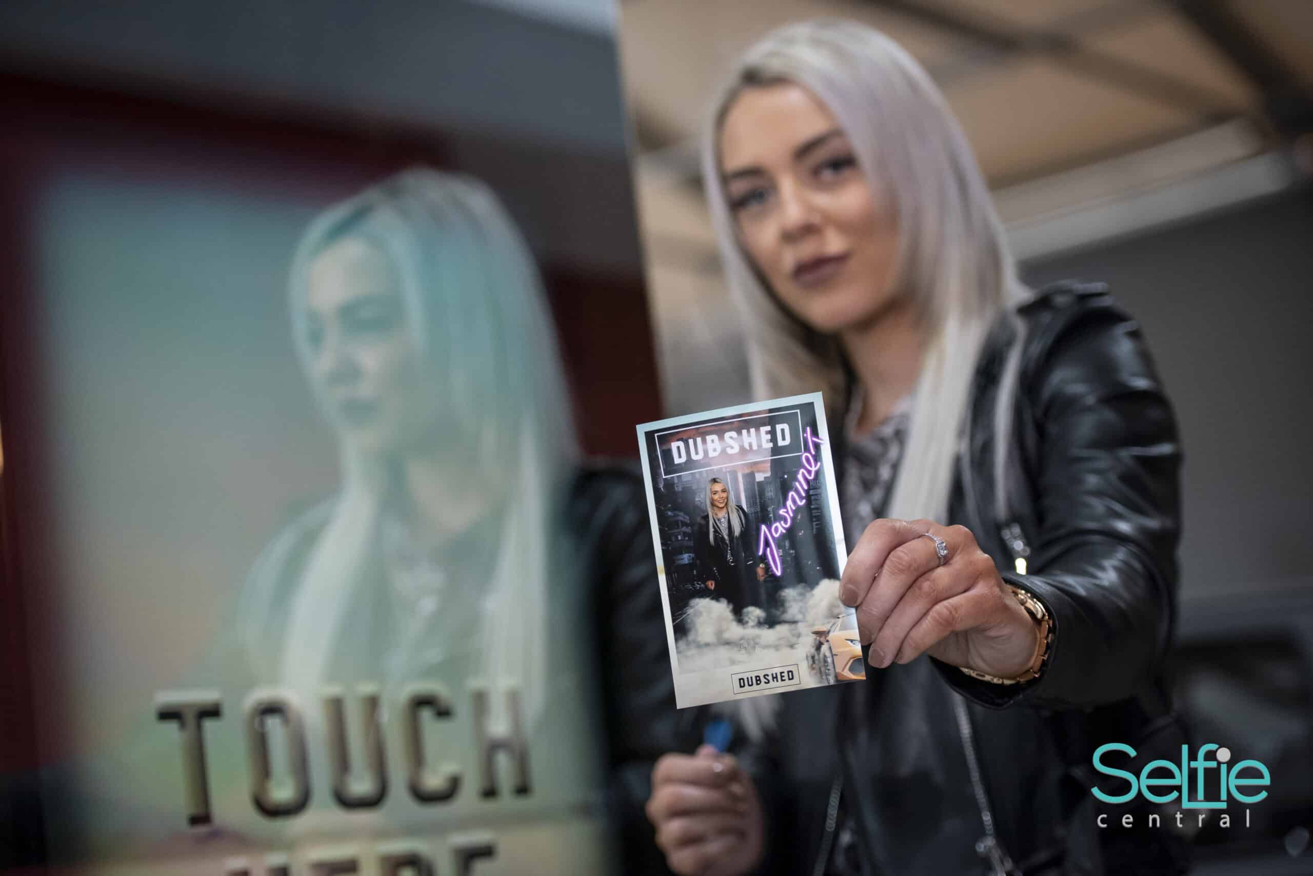 Young woman holding a photo strip at Selfie Central Auckland event.
