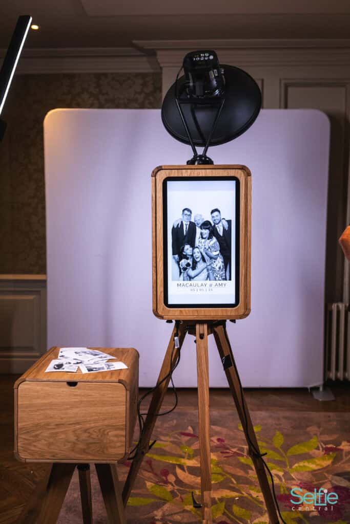 Photo booth with digital screen and camera for event photos in Auckland.