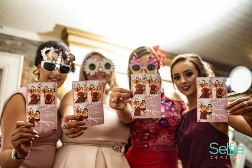 Group of women with fun photo booth props at Selfie Central Auckland.