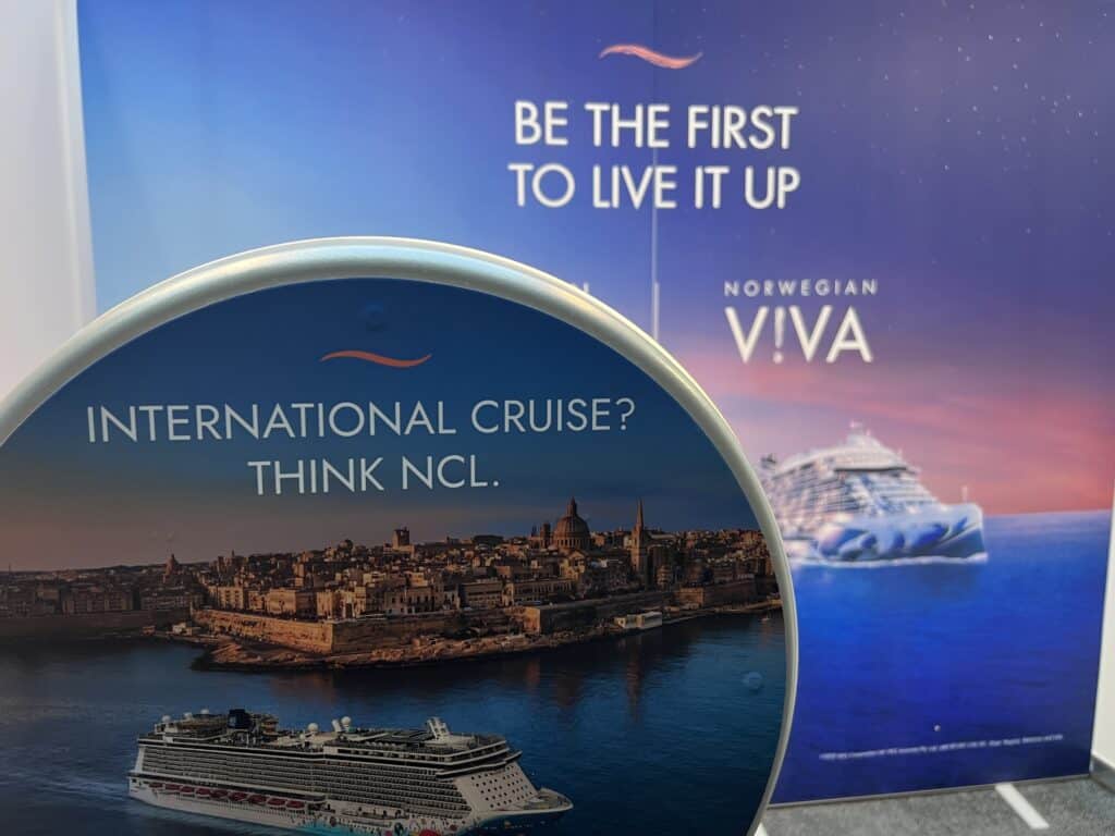 Photo booth at Auckland cruise event with city and cruise ship backdrop.